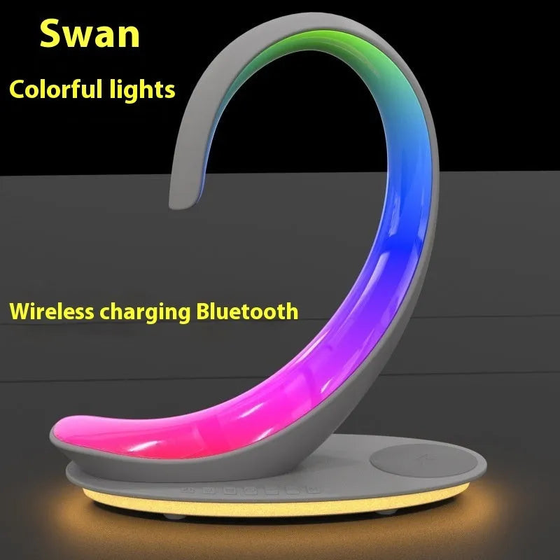 White swan-shaped desktop lamp with wireless charging pad and Bluetooth speaker functions, colourful LED lighting