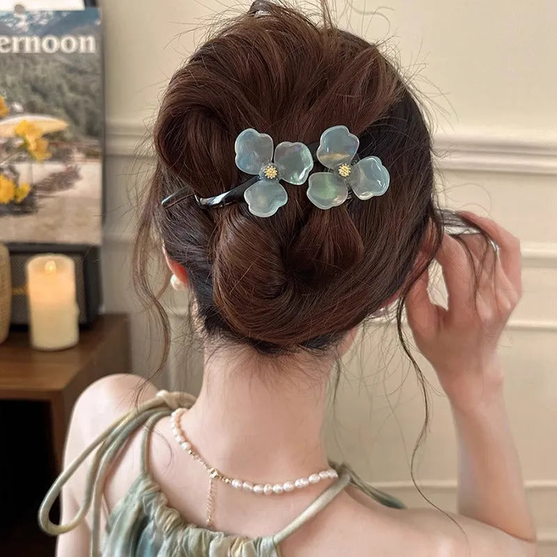Close-up of a retro-style floral bobby pin hair clip with acrylic petals in a choice of colours.