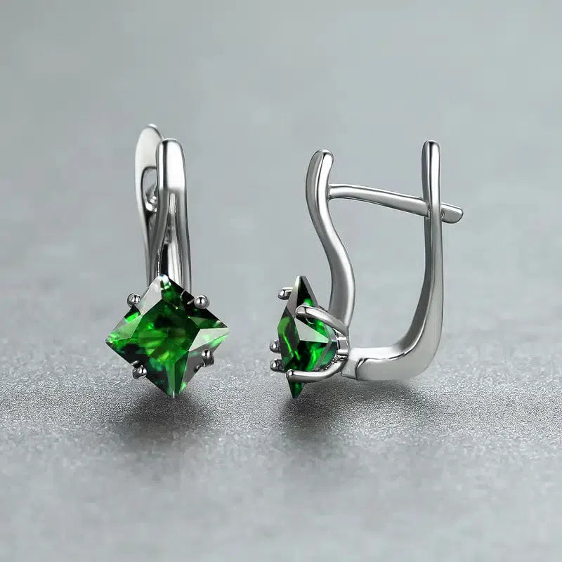 Women's copper earrings with inlaid zircon stones in a diamond design, colour option blue, on a white background