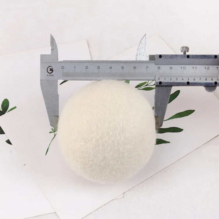 Wool laundry drying ball in various sizes with cotton storage bag for tumble dryer use