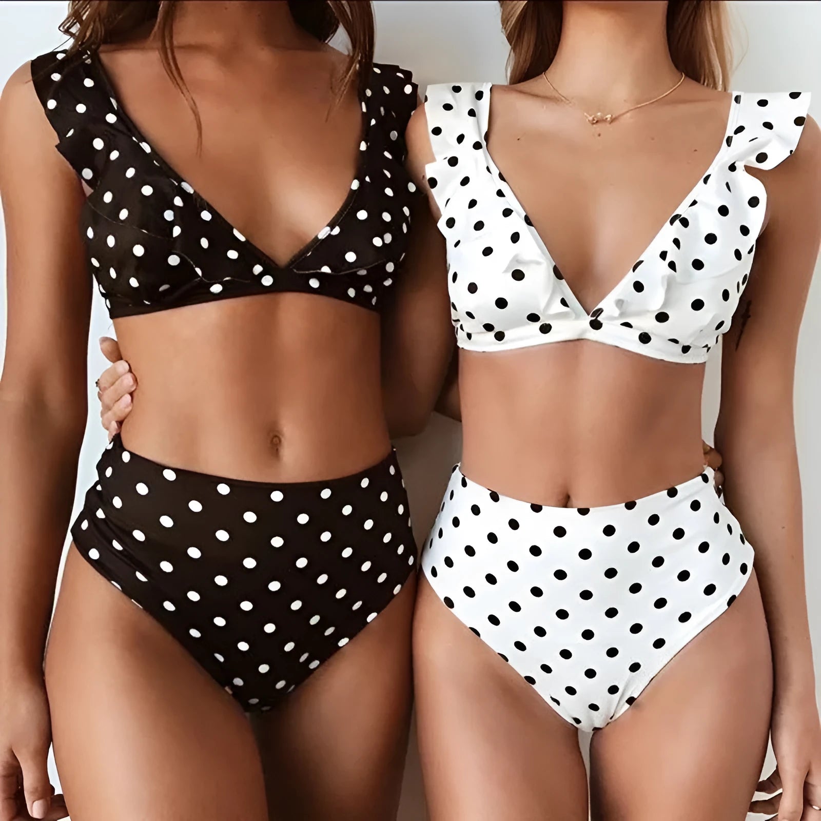 Women's black and white polka dot print bikini set with ruffled deep V-neck top and matching shorts
