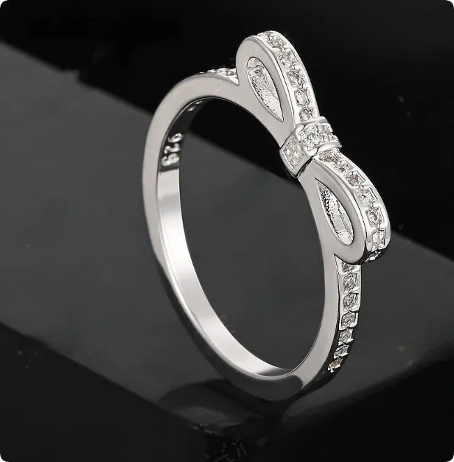 Silver plated fashion ring featuring a detailed 3D bow design set with sparkling zircon crystals on a plain band.