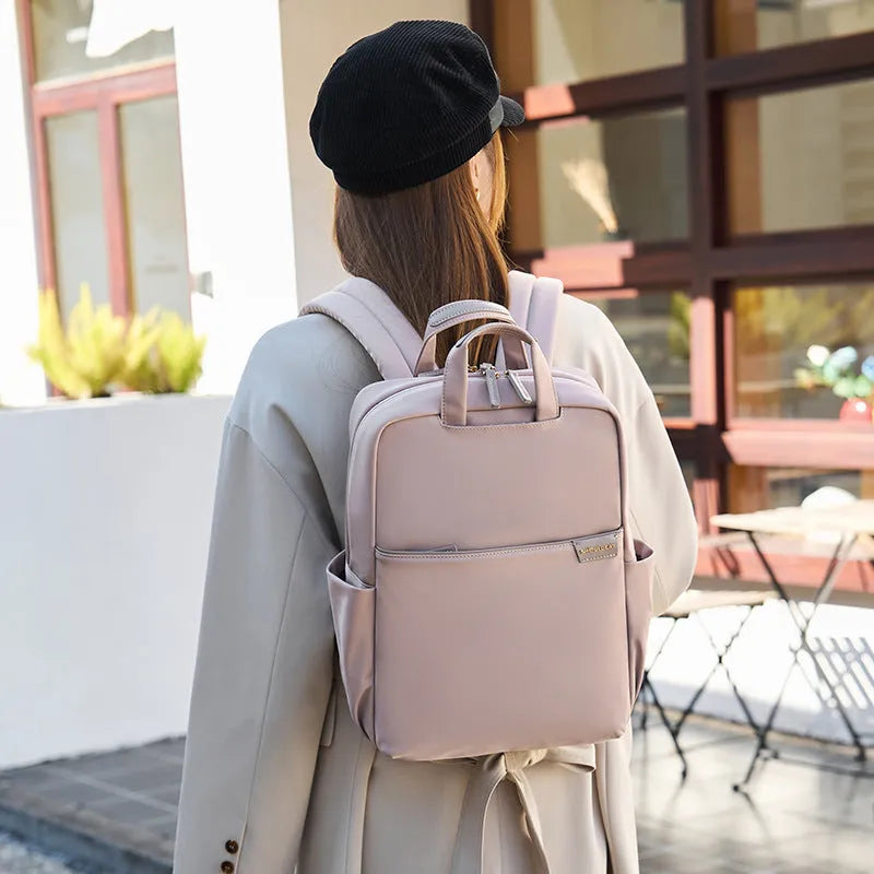 Large canvas travel backpack for women showing multiple internal compartments and zippered pockets