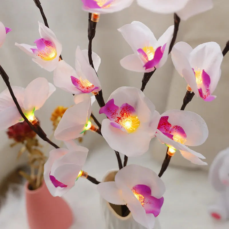 A 65cm tall pink LED phalaenopsis orchid branch light with fabric petals, powered by batteries.