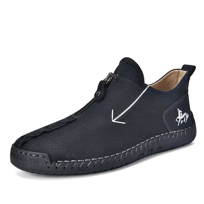Men's black leather ankle boots with a front zip and round toe on a rubber sole