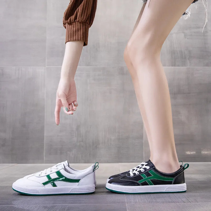 Women's white and black leather sneakers with elastic band closure and round toe