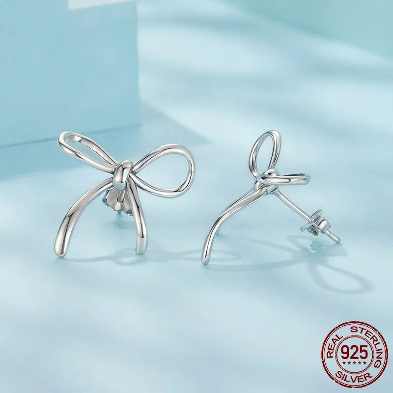 Simple S925 sterling silver stud earrings with polished finish on white background