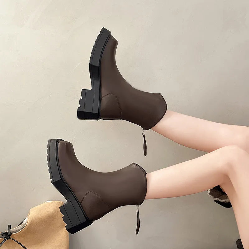 Black platform Martin boots for women with a square toe and back zipper on a rubber sole.