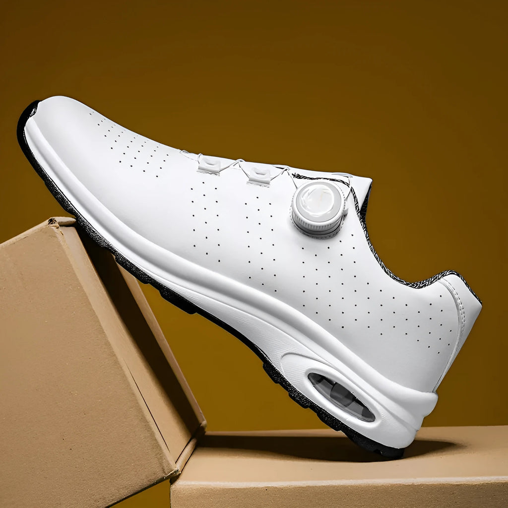 Black and white low top casual tennis shoes with cross shoulder straps and mesh upper.