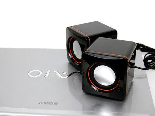 Black, small square USB-powered 2.0 computer speaker for desktop use.