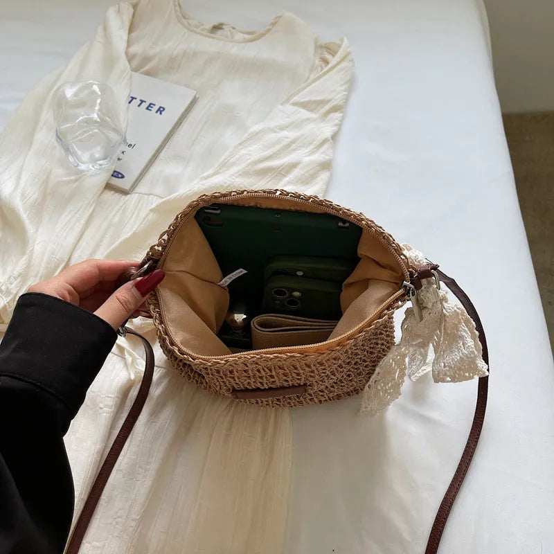 Women's woven straw messenger bag in khaki colour, showing hollowed texture and single shoulder strap.