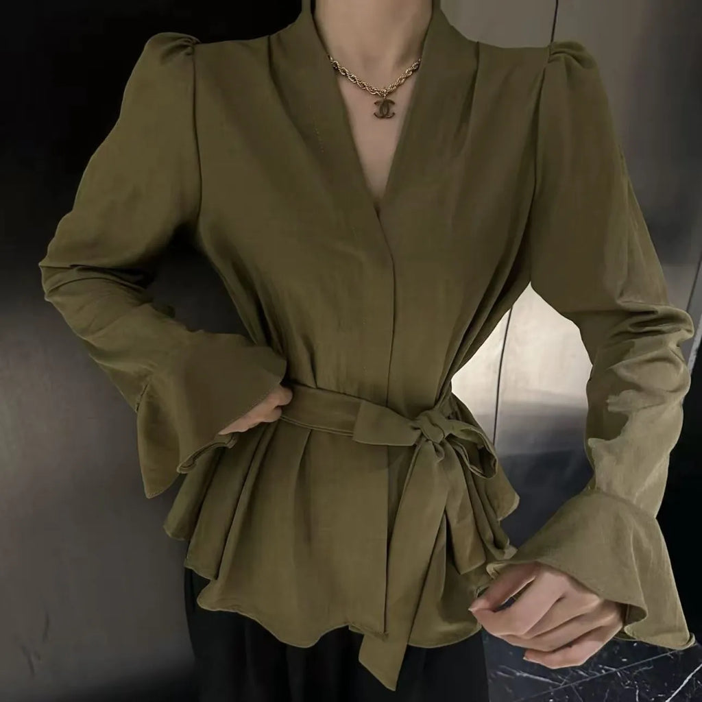Black women's French-style shirt with irregular collar, long bell sleeves and tied front detail.