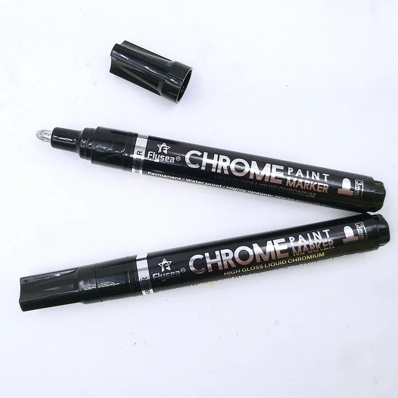 Chrome-plated reflective paint marker pen with 3.0mm tip on glass surface showing silver writing
