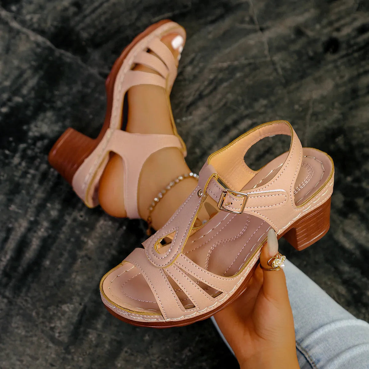 Women's black peep toe wedge platform sandals with a buckle fastening on a grey background