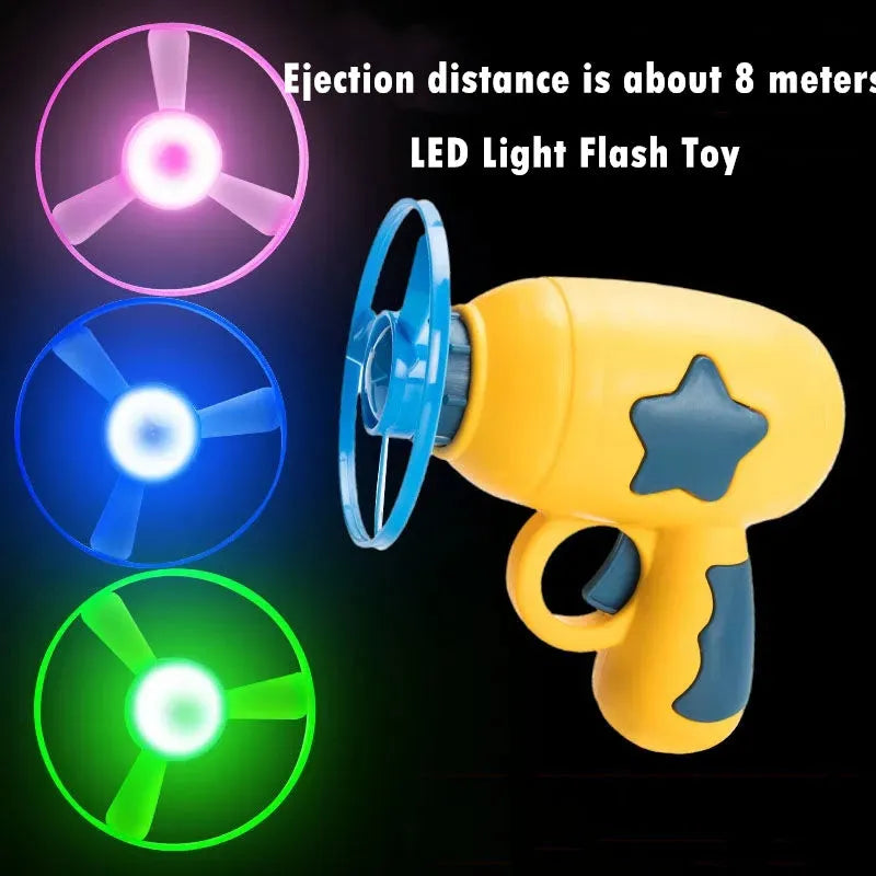 Blue and yellow LED light-up flying saucer launcher toy set with plastic gun and three discs.