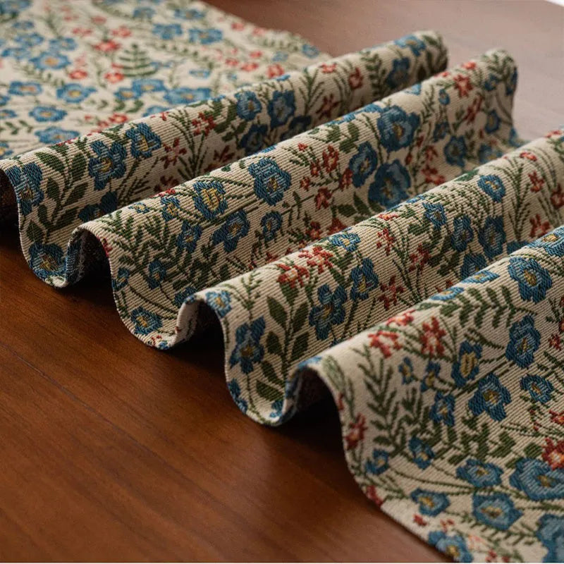 Dark blue Nordic stripe pattern jacquard table runner with tassel detail on a wooden table.