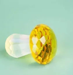 Modern geometric crystal mushroom decoration in transparent, green, red, or yellow, 40 by 53 millimetres.