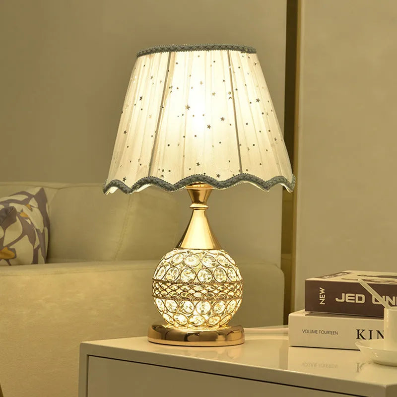 Gold crystal desk lamp with hand-finished pendant and iron art base on wooden surface