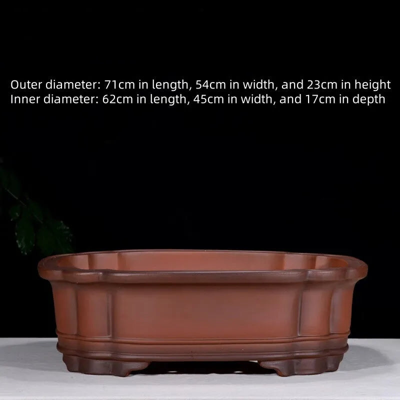Large antique-style Chinese purple clay flowerpot with tree stump and floral relief pattern.