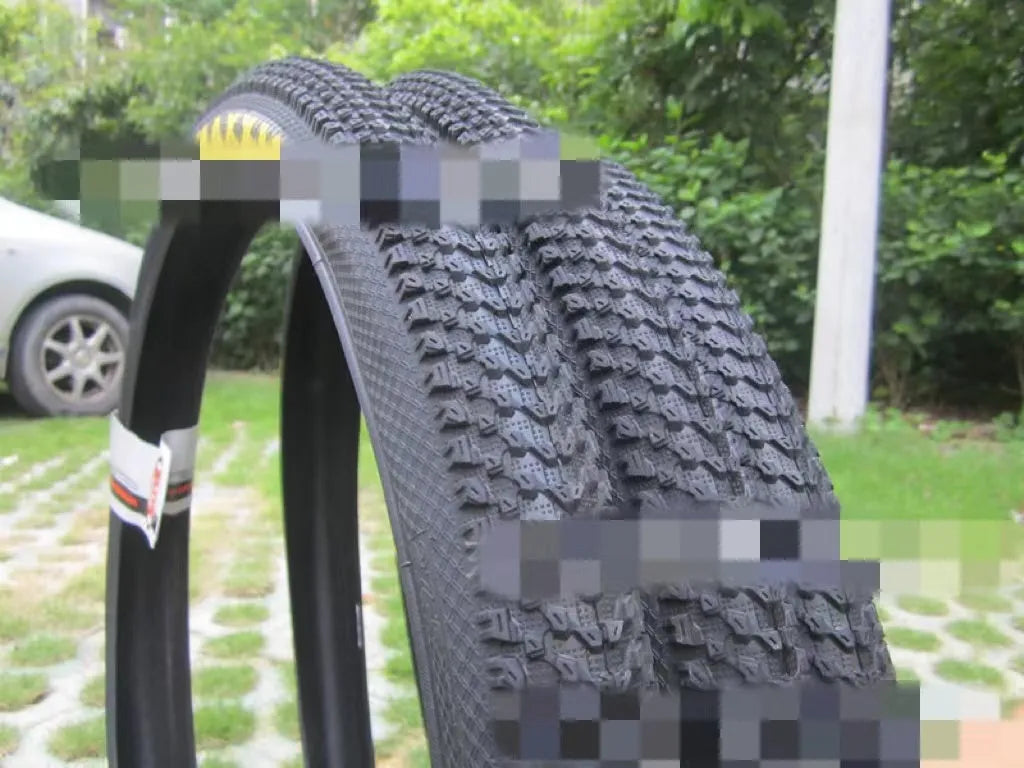 Mountain bike tyre with tread, shown in multiple size options: 26, 27.5 and 29 inch diameters.