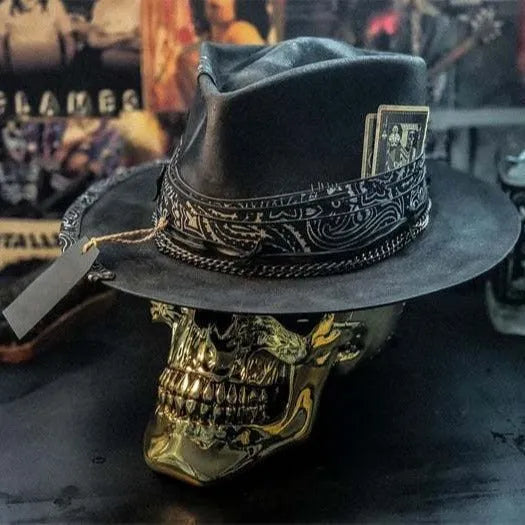 Handmade grey wool felt conical hat with a black embroidered skull design on the front.