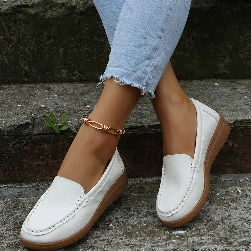 Women's flat slip-on shoes in PU leather, shown in multiple colours with a round toe and rubber sole.