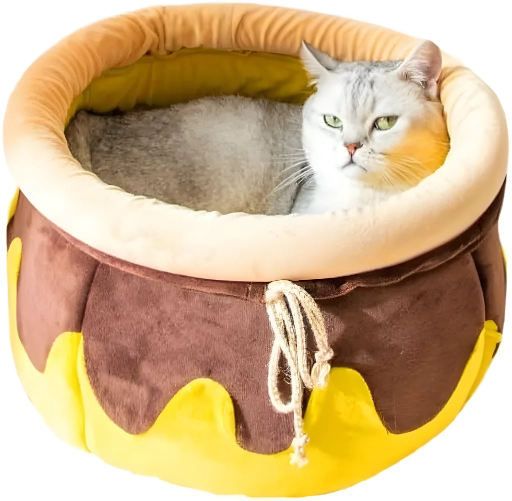 Pink or yellow honey pot-shaped enclosed cat bed with a magic wand decoration and a removable cushion.