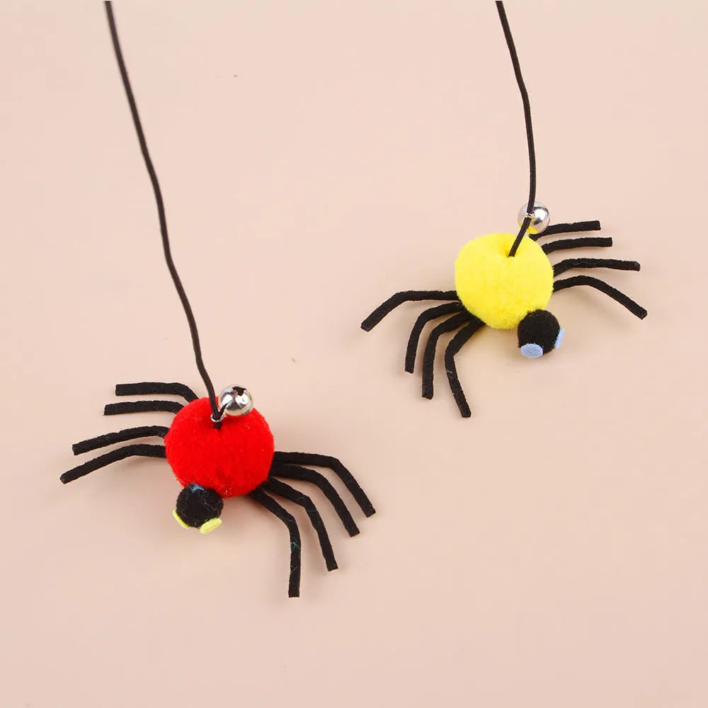 Red hanging cat toy with elastic rope, feathers, and bell spider ornament mounted on door