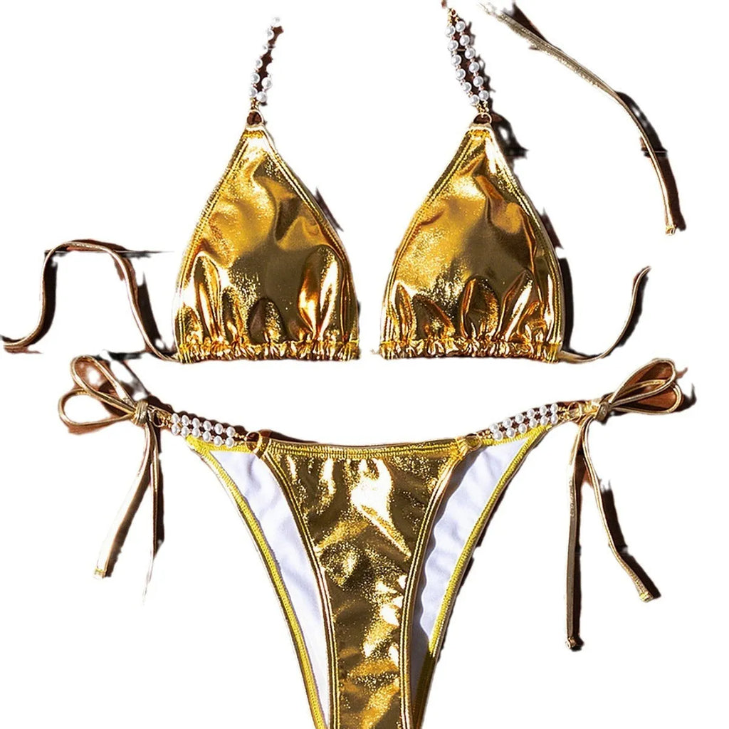 Gold halter lace-up bikini with pearl chain detail on mannequin showing front view