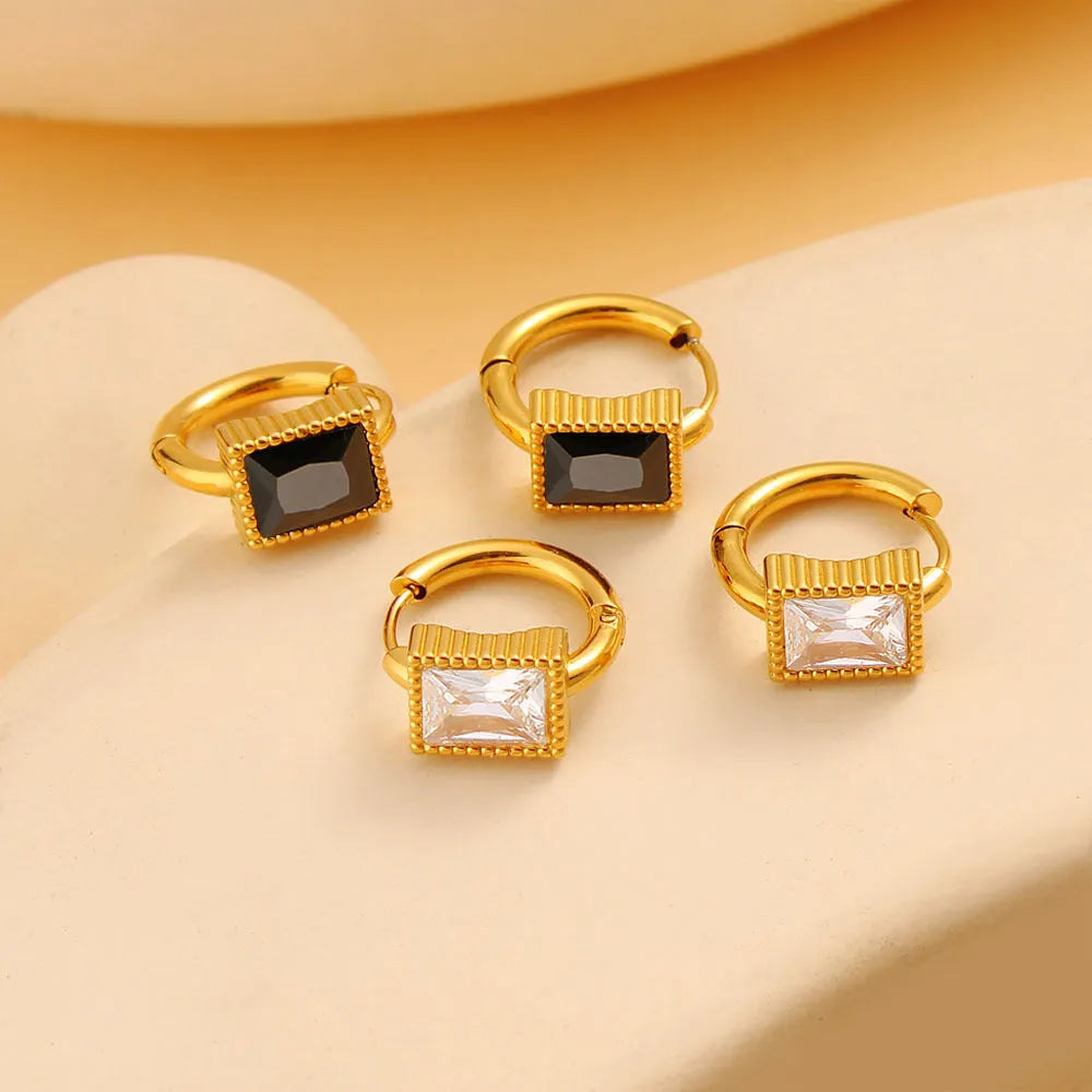 Geometric stainless steel earrings with a square zircon centre and round ring detail in black, green, or white.