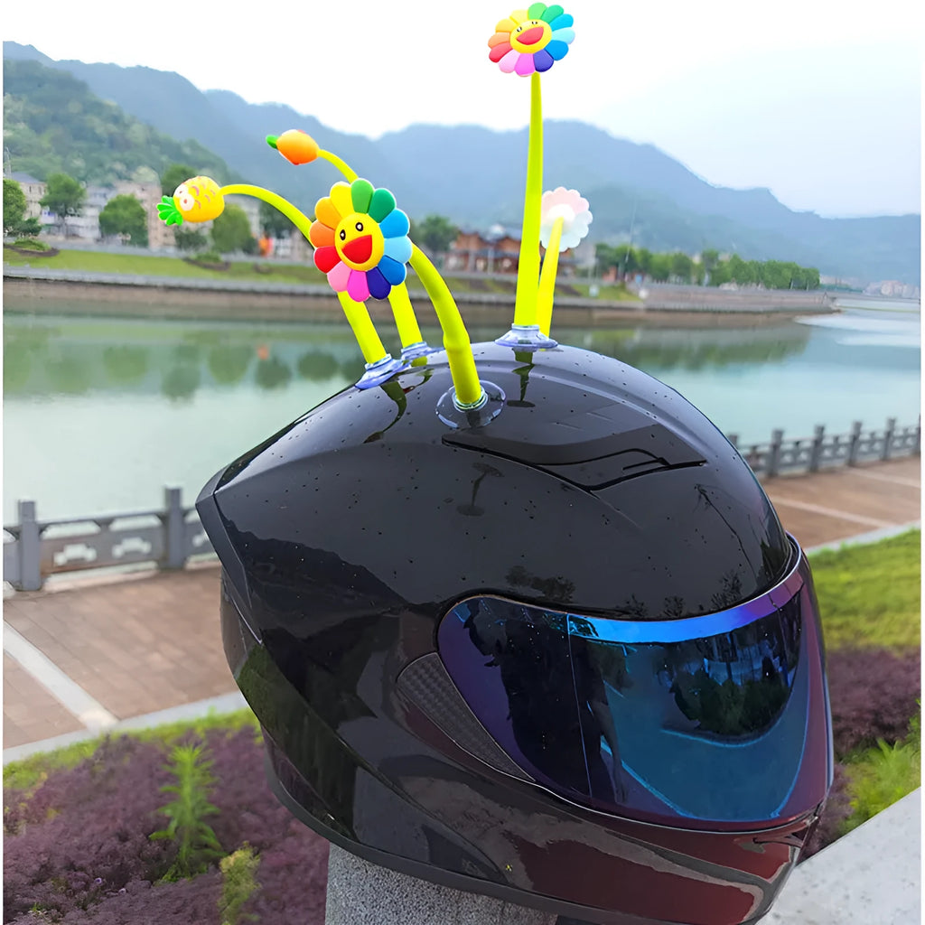 Yellow silicone sunflower helmet decoration with a brown centre and a clear suction cup for attachment.