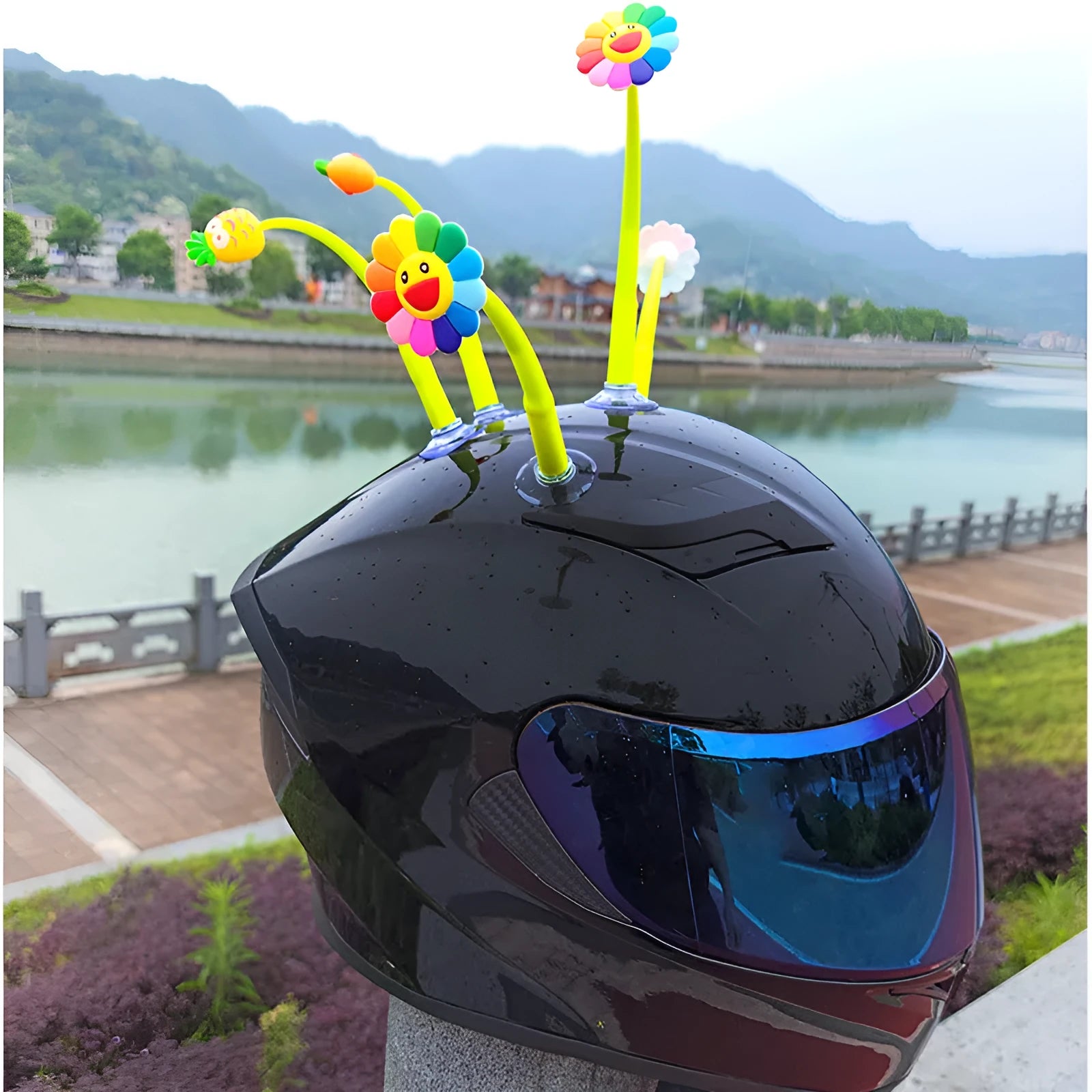 Yellow silicone sunflower helmet decoration with a brown centre and a clear suction cup for attachment.