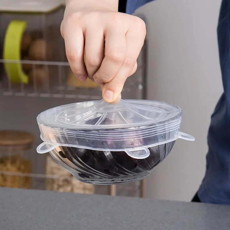 Set of six colourful silicone stretch lids in different sizes for covering bowls and food containers.