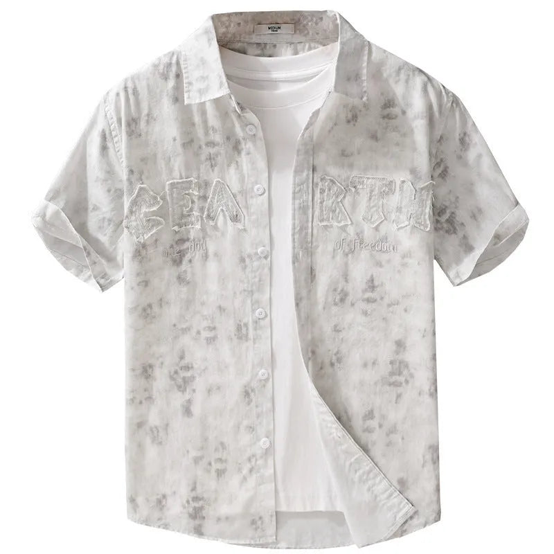 Man wearing a grey white pure cotton short sleeve cardigan with a hanging dyed print and loose fit.