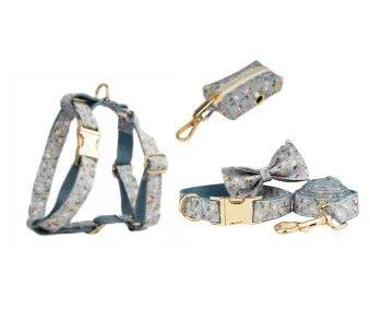 Floral print dog collar and leash set with matching bow, vest, and poop bag holder.