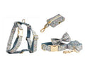 Floral print dog collar and leash set with matching bow, vest, and poop bag holder.