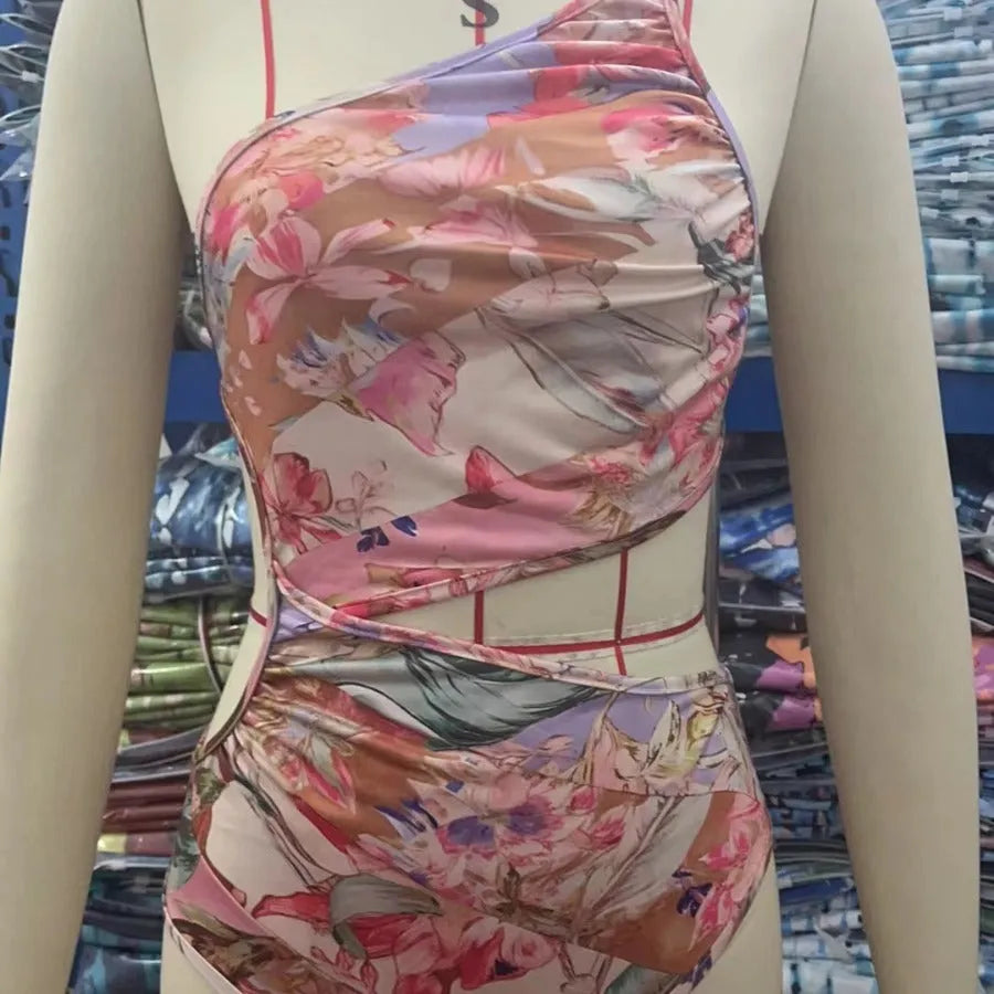 Women's rose gold patterned one-piece swimsuit on hanger