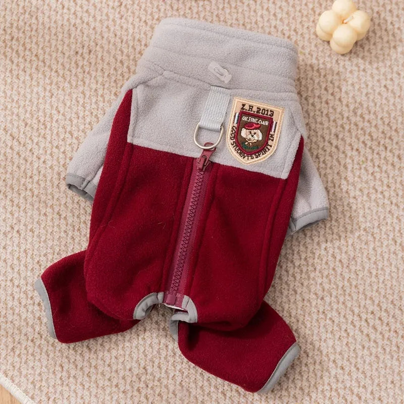 Four-legged fleece pet jacket in colour block design with full zipper and badge patch, sizes S-XXL for cats and small dogs.