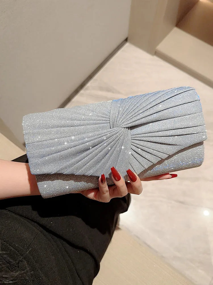 Horizontal square dinner clutch in silver or gold with woven exterior, open pocket, and internal phone bag.