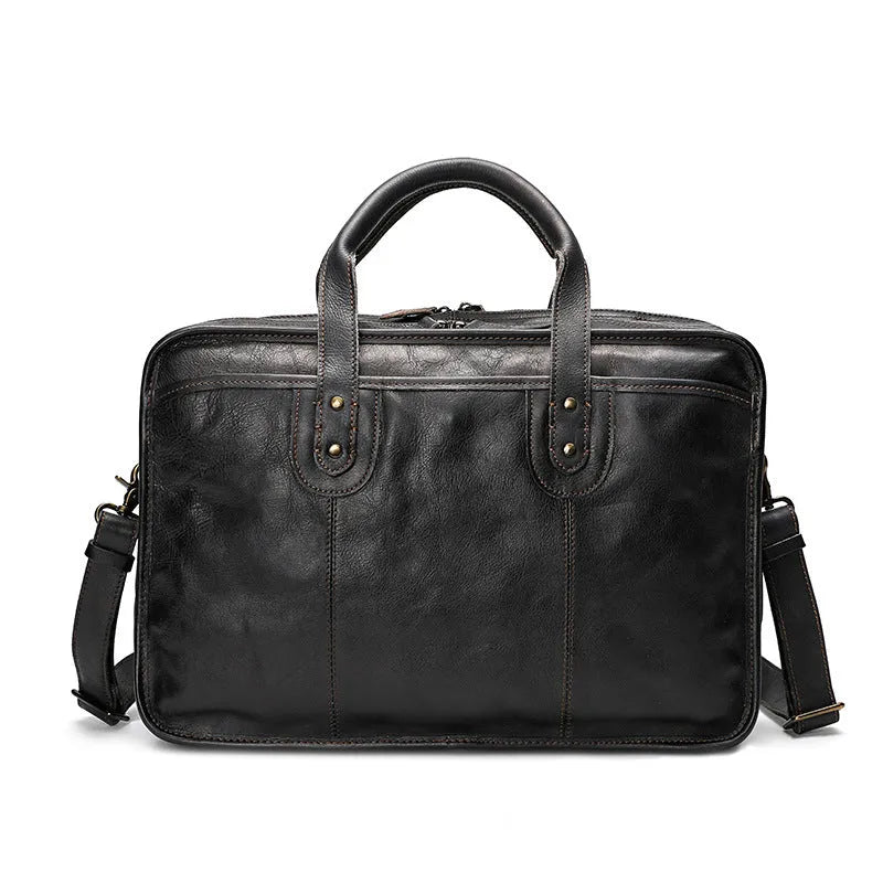 Brown vintage men's leather briefcase open to show internal laptop, document, and camera pockets.