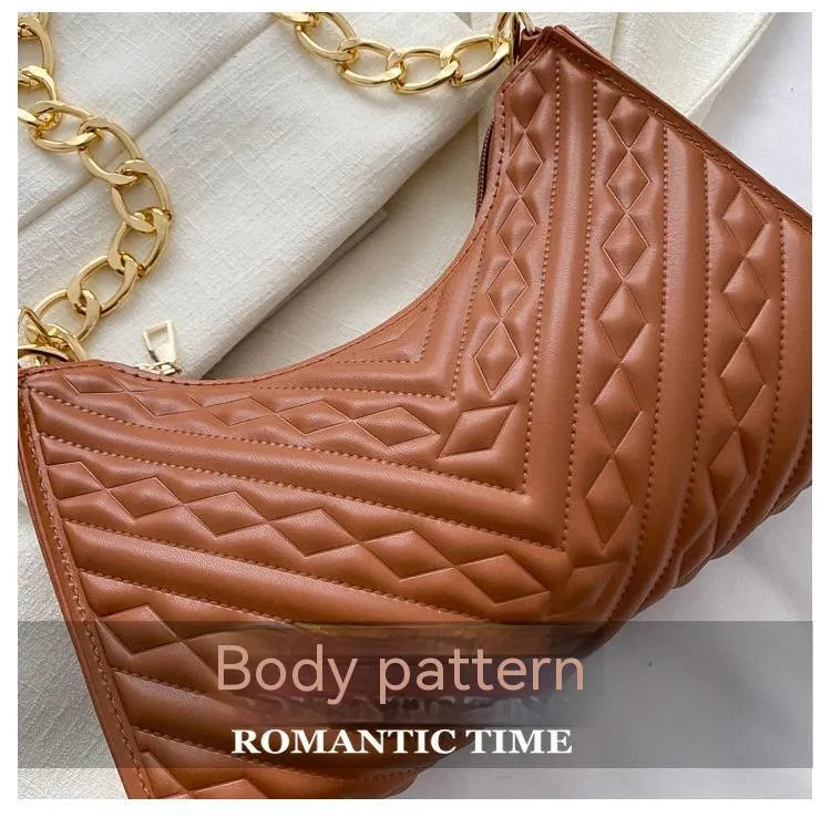 A structured black pleated women's shoulder bag with a chain strap and a soft handle, showing its square shape.