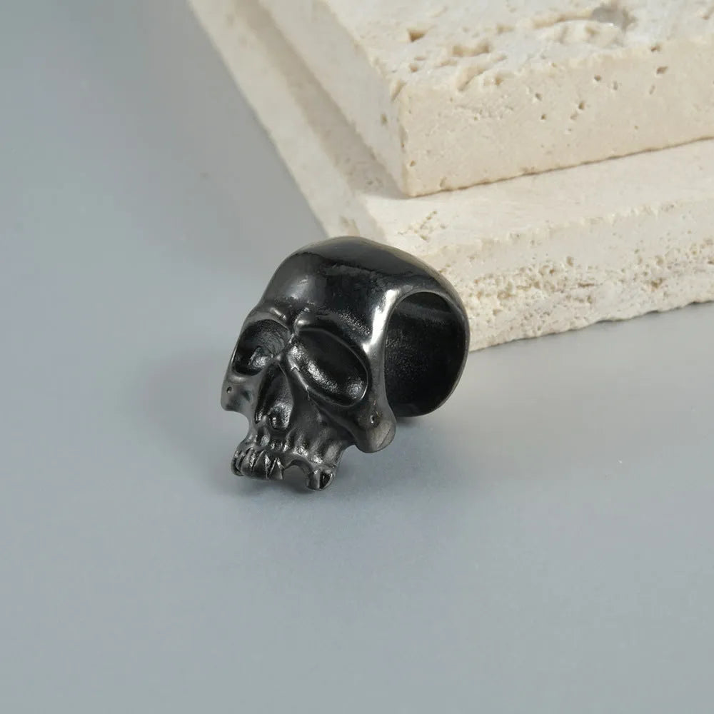 Stainless steel hollow skull Buddha head earrings for auricle piercing in hip hop style.
