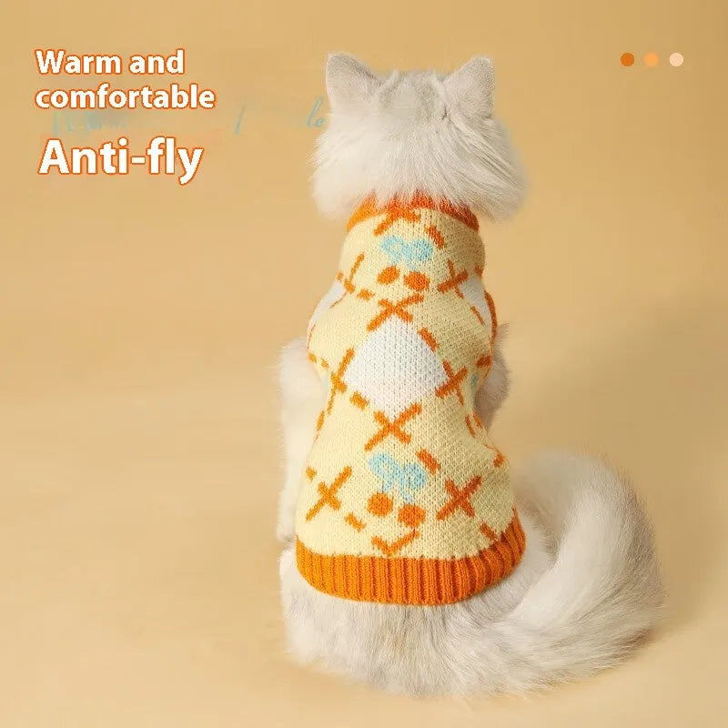 Orange cherry pattern cat sweater for autumn and winter wear, shown in pet clothing context.