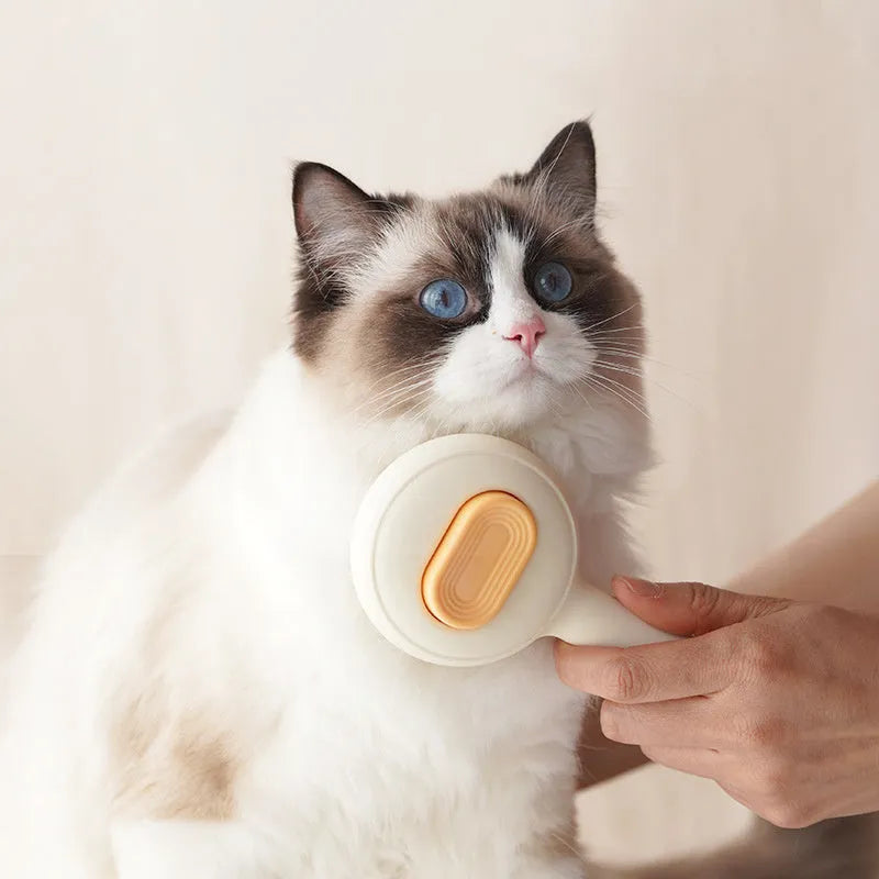 Green and yellow cat grooming brush with stainless steel pins and non-slip ergonomic handle