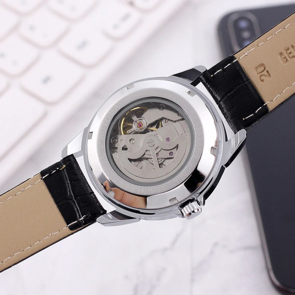 Men's transparent skeleton quartz watch with genuine leather strap on wrist, 37mm dial, alloy case, and stainless steel buckle