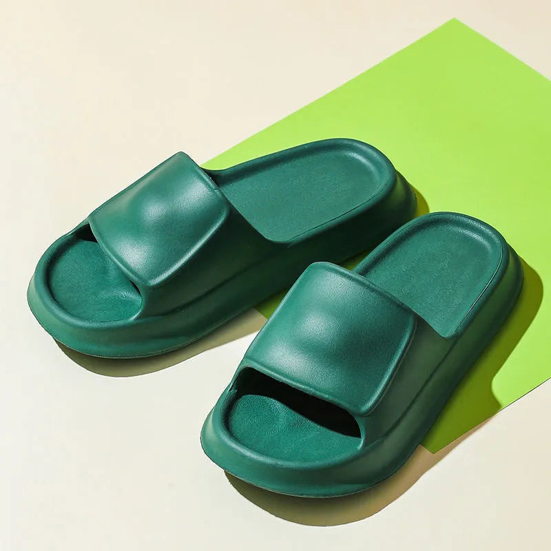 Pair of thick-soled white EVA flip-flop slippers with a non-slip patterned sole.