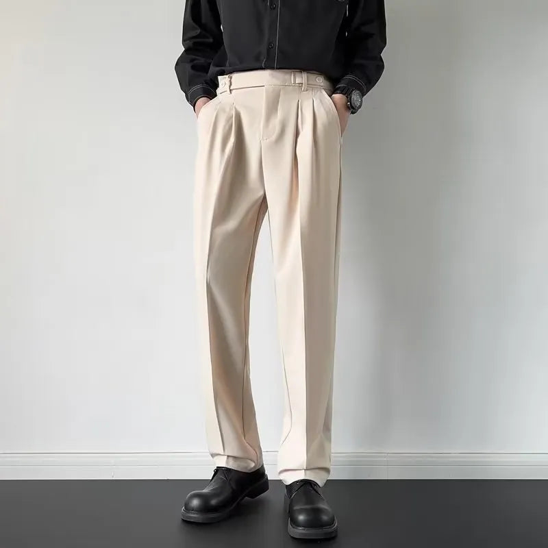 Men's straight leg loose fit suit trousers in apricot colour hanging on a hanger.