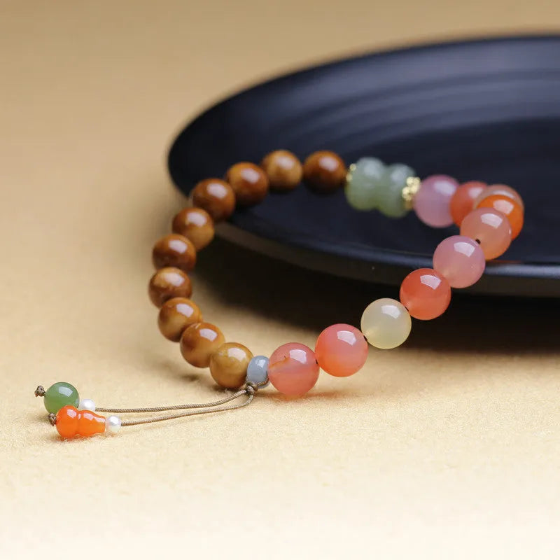 Handmade 8mm agate bracelet with diamond-shaped beads in natural persimmon colour tones