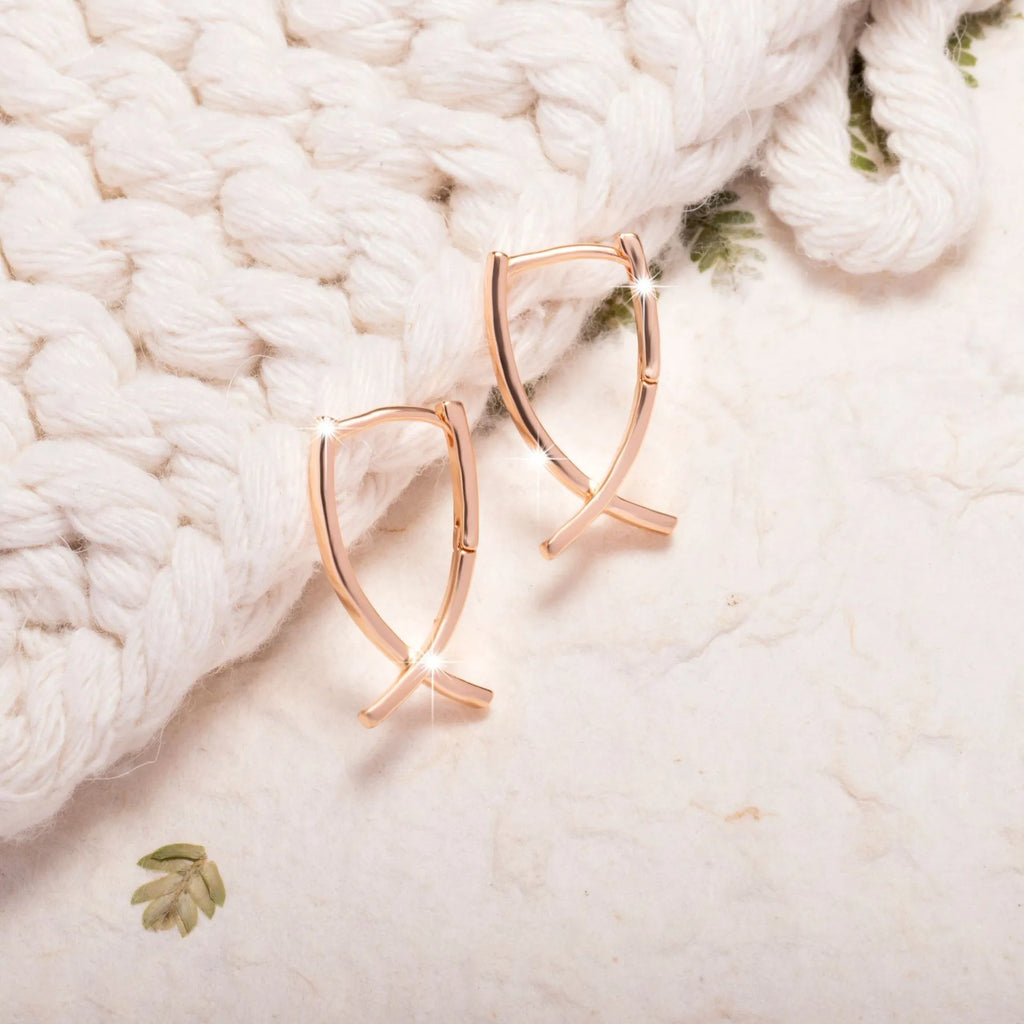 Rose gold plated cross-shaped earrings showing front design with post fitting.