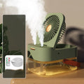Portable pearl white USB desktop humidifier fan with night light on a wooden desk.